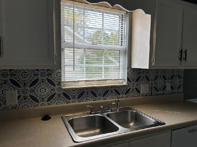 kitchen featuring decorative backsplash, sink, and a wealth of natural light