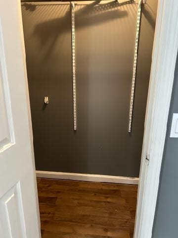 walk in closet featuring dark wood-type flooring