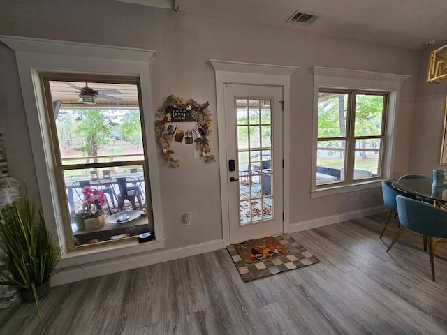 doorway featuring ceiling fan and wood-type flooring