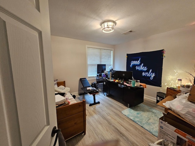 office space with light hardwood / wood-style floors and a textured ceiling