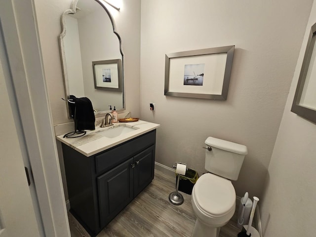 bathroom featuring hardwood / wood-style floors, vanity, and toilet