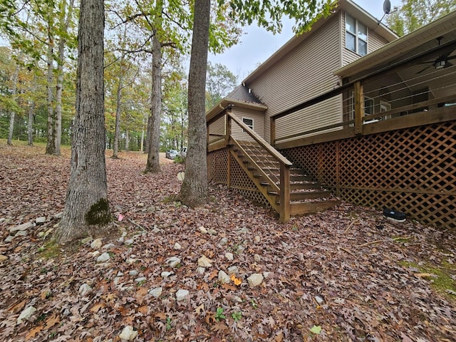 view of yard with ceiling fan and a deck