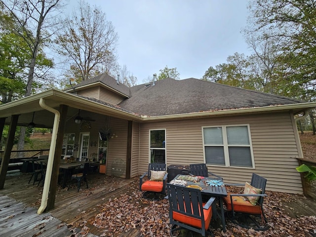 rear view of property featuring a wooden deck and ceiling fan