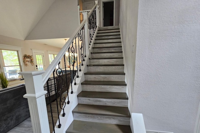 stairway with vaulted ceiling