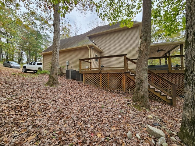 view of home's exterior featuring cooling unit and a wooden deck