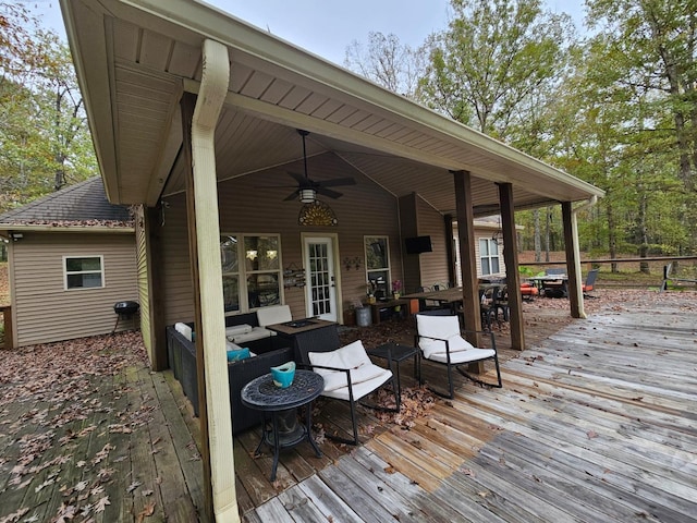 wooden deck with ceiling fan and an outdoor hangout area