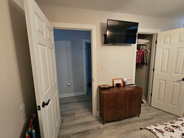 bedroom featuring light hardwood / wood-style flooring and a closet