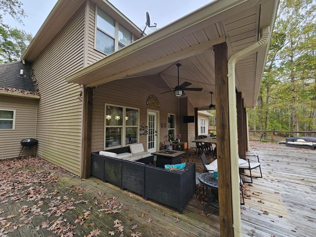 deck with ceiling fan and an outdoor living space with a fire pit