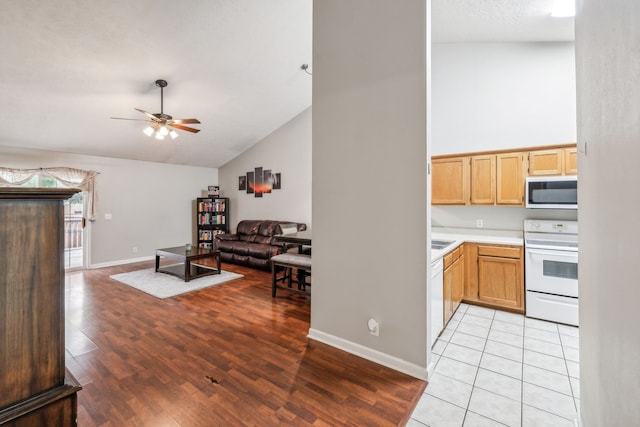 kitchen featuring electric range, light hardwood / wood-style flooring, ceiling fan, and high vaulted ceiling