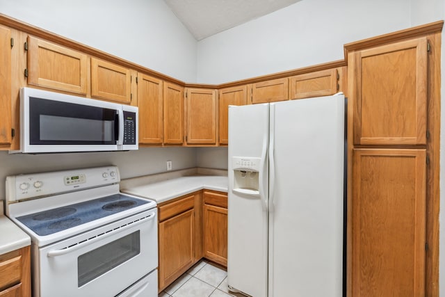 kitchen with white appliances and light tile patterned flooring