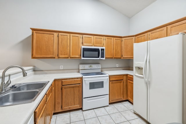 kitchen with light tile patterned floors, white appliances, high vaulted ceiling, and sink