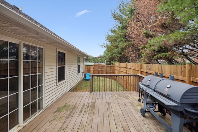 wooden terrace featuring a grill