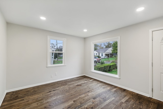 empty room featuring dark hardwood / wood-style flooring