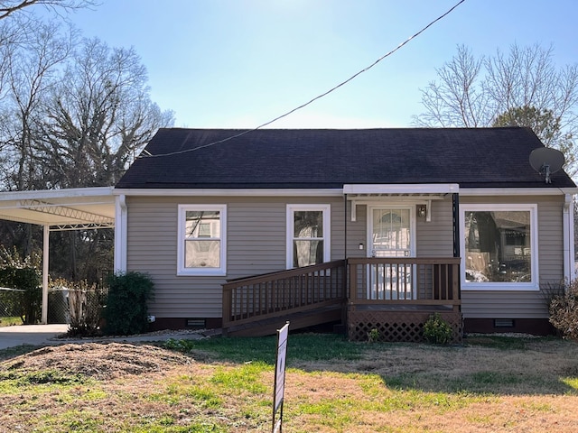 bungalow featuring a carport and a front lawn