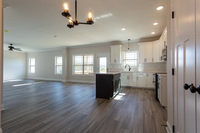 kitchen featuring hanging light fixtures, a center island, white cabinets, and dark wood-type flooring