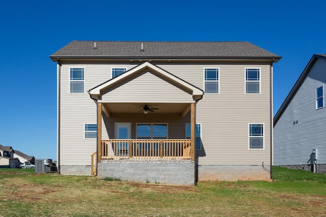 back of property with covered porch, central air condition unit, ceiling fan, and a lawn