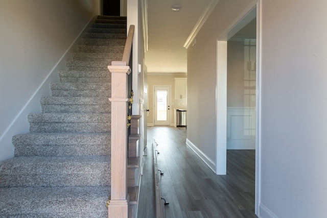 staircase featuring hardwood / wood-style floors and crown molding