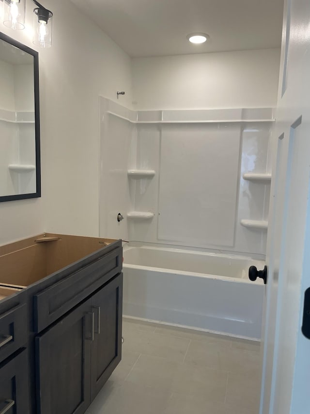 bathroom featuring vanity, tile patterned flooring, and tub / shower combination