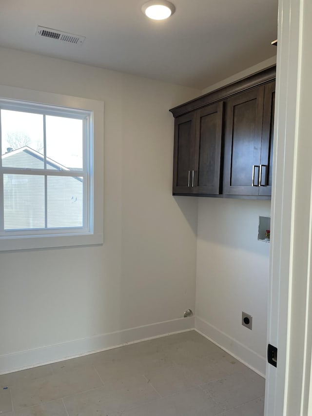 washroom featuring cabinets, hookup for an electric dryer, and hookup for a washing machine