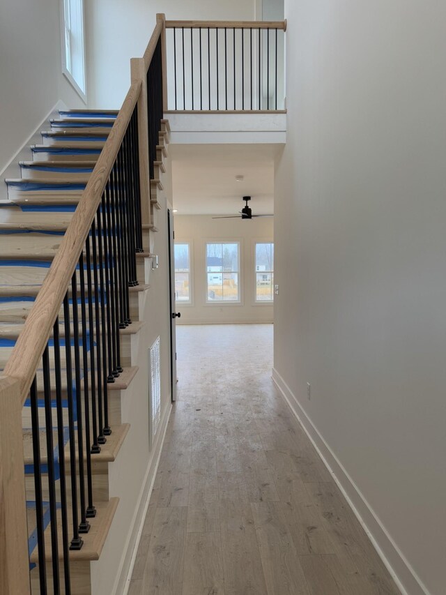 interior space with hardwood / wood-style flooring and a high ceiling