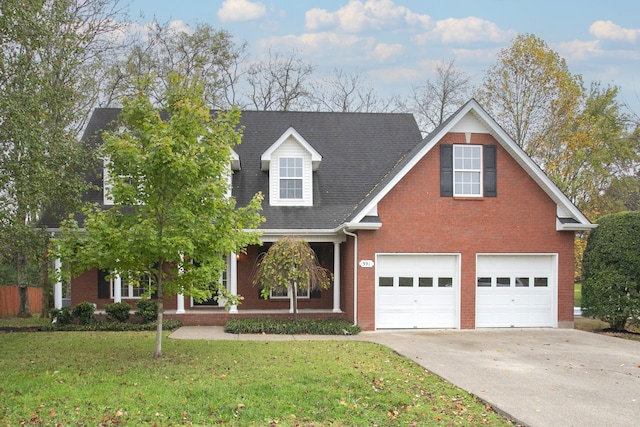 view of front of house featuring a garage and a front lawn