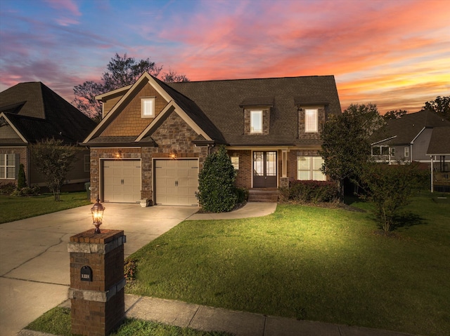 view of front of home with a garage and a yard