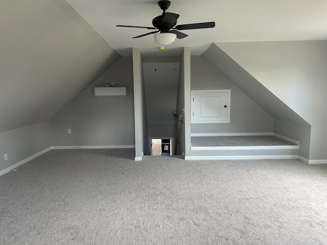 additional living space featuring vaulted ceiling, carpet, ceiling fan, and a wall unit AC