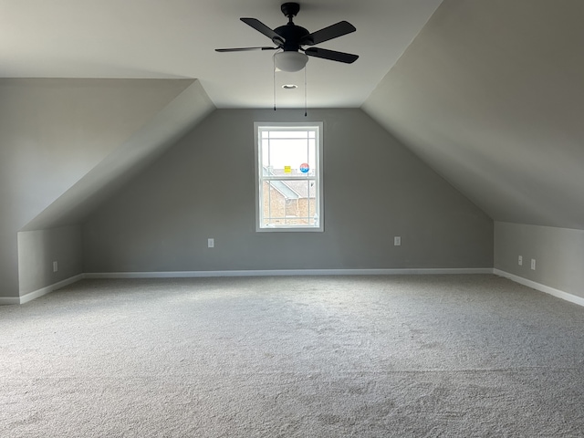 bonus room featuring lofted ceiling, carpet, and ceiling fan