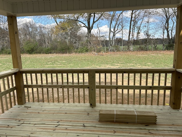 wooden deck with a lawn