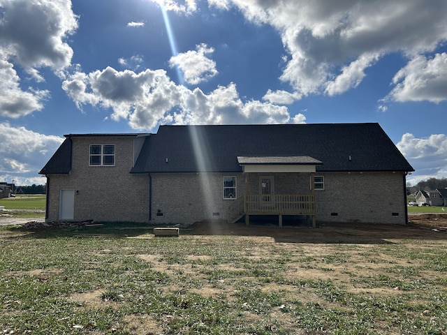 rear view of property featuring a wooden deck