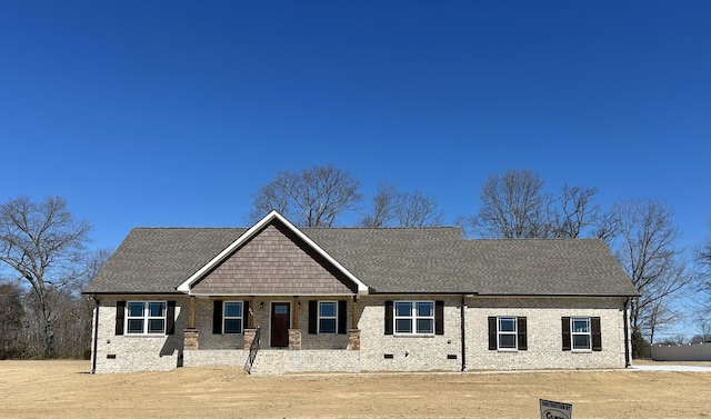 craftsman inspired home with brick siding, crawl space, and a shingled roof