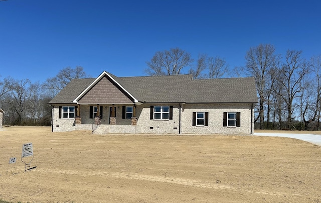 craftsman-style house with crawl space, a shingled roof, and brick siding