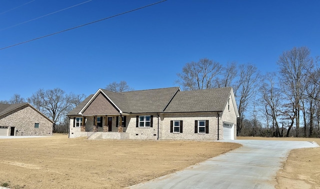 view of front facade with brick siding, roof with shingles, concrete driveway, crawl space, and a garage