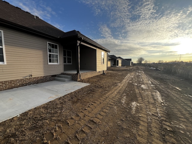 property exterior at dusk with a patio