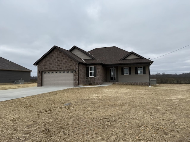 view of front of house featuring central AC unit and a garage