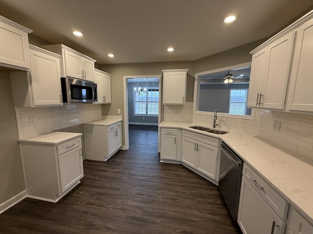 kitchen featuring sink, white cabinets, dark wood-type flooring, and appliances with stainless steel finishes