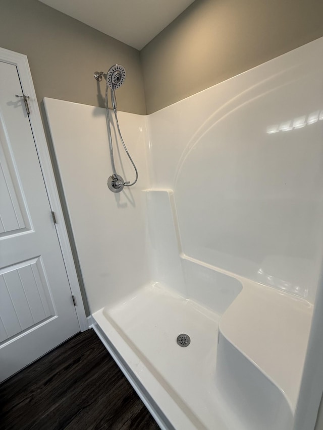 bathroom featuring hardwood / wood-style floors and walk in shower