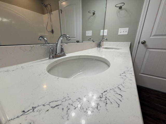 interior details with vanity and walk in shower