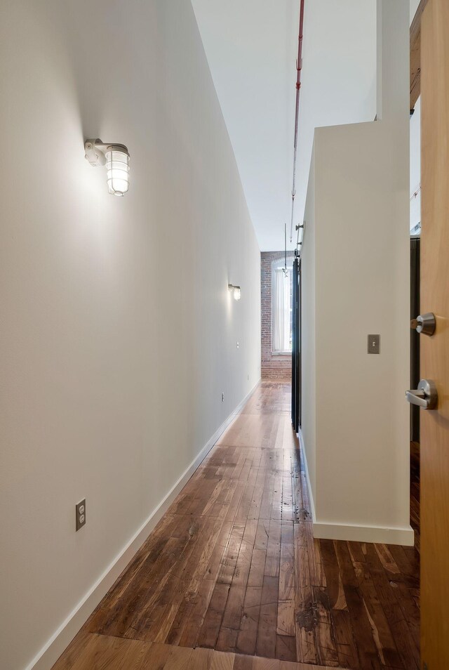 hall with hardwood / wood-style flooring and baseboards