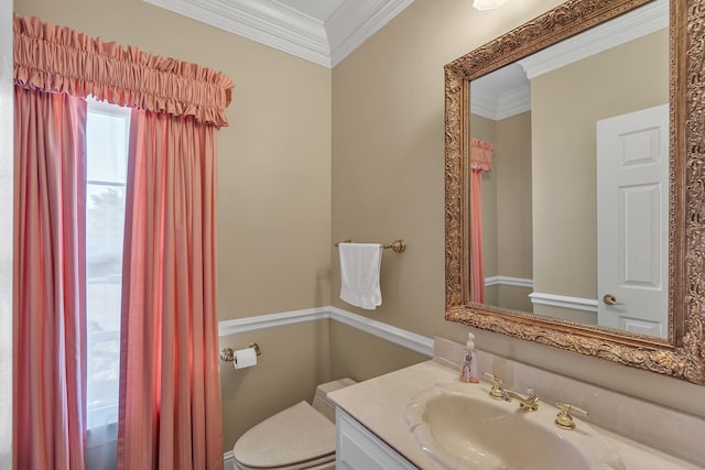 bathroom with vanity, toilet, and ornamental molding