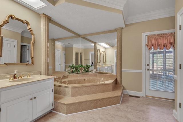 bathroom featuring tiled bath, crown molding, and vanity