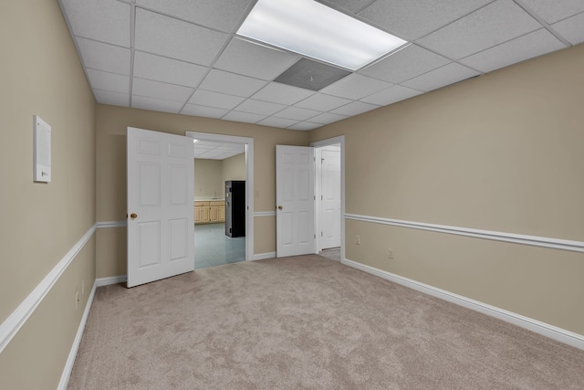 interior space with a paneled ceiling