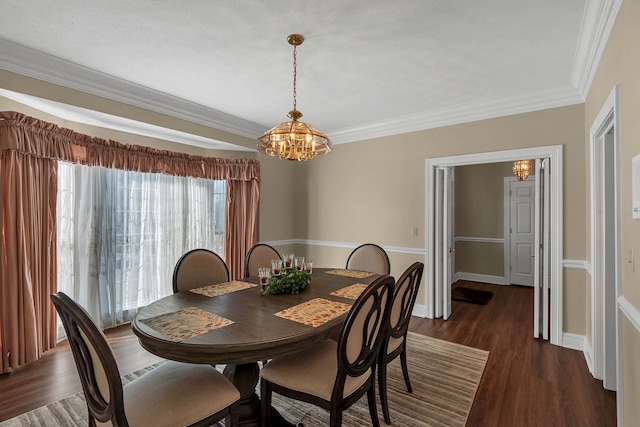 dining area featuring dark wood-type flooring, a notable chandelier, and ornamental molding