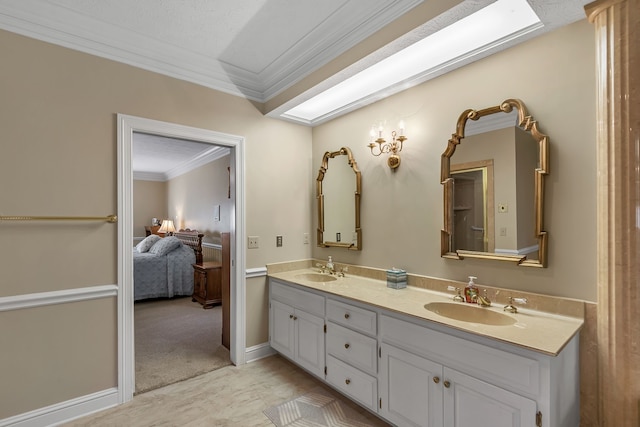 bathroom featuring vanity, a textured ceiling, and ornamental molding