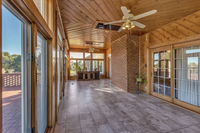 unfurnished sunroom with ceiling fan, lofted ceiling, and wood ceiling