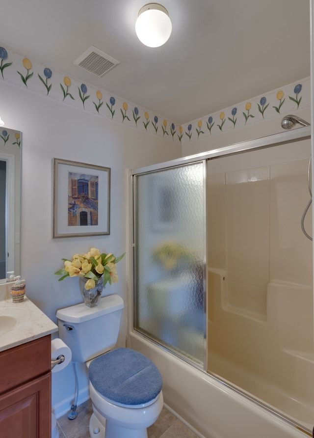 full bathroom featuring tile patterned flooring, vanity, toilet, and enclosed tub / shower combo