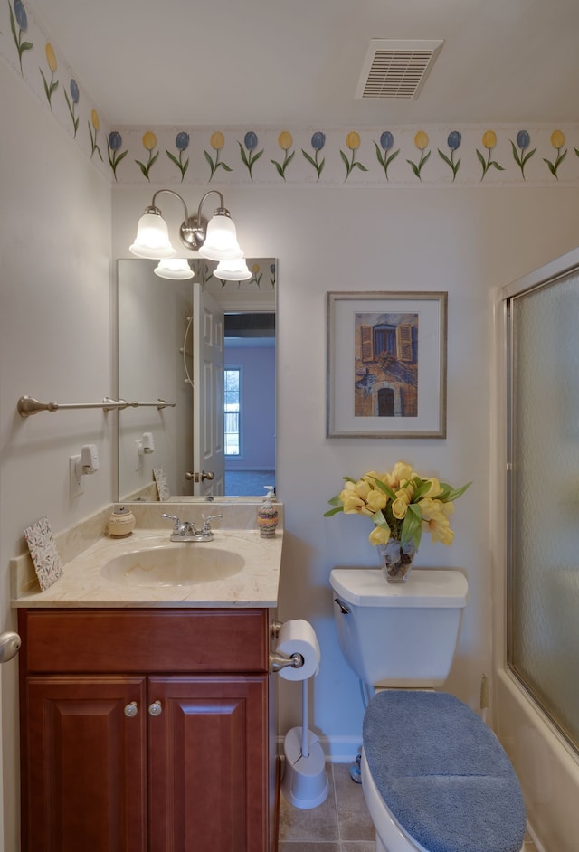 full bathroom with toilet, vanity, tile patterned floors, and shower / bath combination with glass door