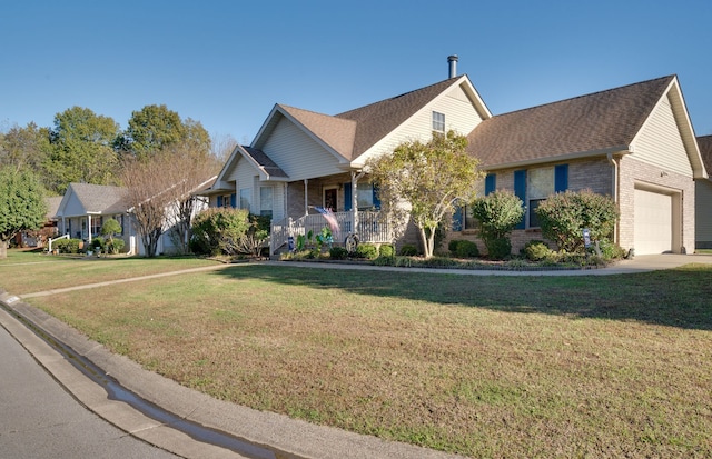 view of front of property featuring a porch, a garage, and a front lawn