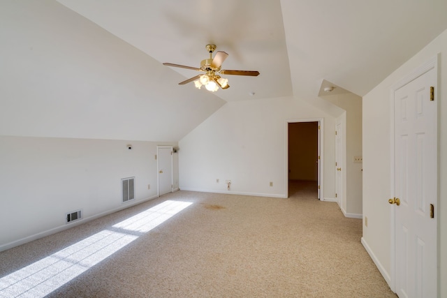 additional living space with light carpet, ceiling fan, and lofted ceiling