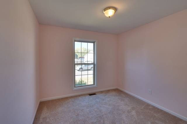 empty room with light colored carpet